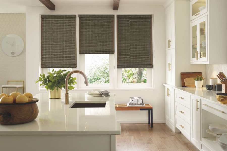 Gray woven window shades on 3 windows in a kitchen